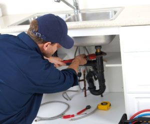 Plumber fixing sink