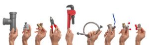 people holding plumbing tools