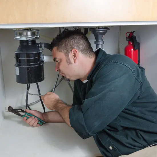 man working on plumbing