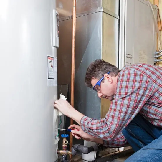 man working on water heater