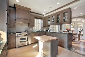 Kitchen in remodeled home with wood cabinetry and island