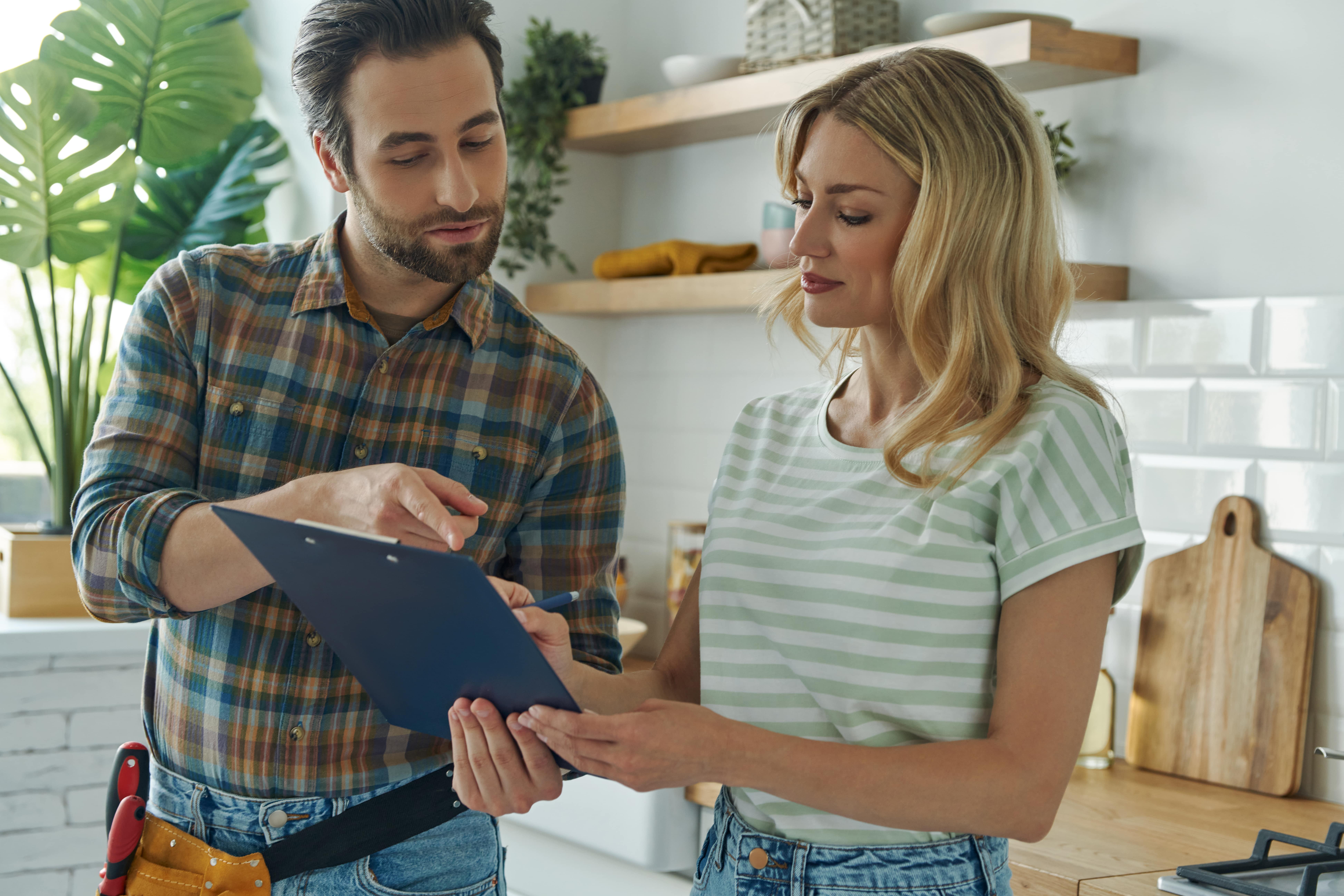 woman talking to plumber