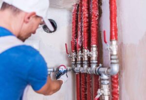 plumbing expert checking pipes for leaks and repairs