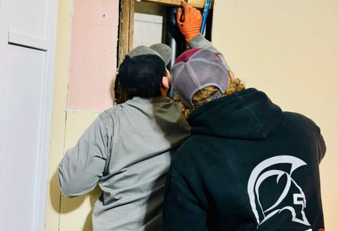 Spartan Plumbing Service Technician checking walls for plumbing