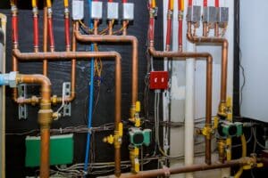 Heating system's copper pipes with ball valves on pipes collector of underfloor heating system pump and pipes