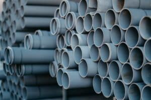 A selective focus shot of blue-grey pipes of the same sizes put together